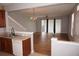 Open-concept kitchen features wood cabinets, a tiled floor, and a view of the adjacent living room at 1034 Enclair St, Orlando, FL 32828