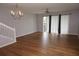 Spacious living room featuring wood floors, a ceiling fan, and sliding glass doors to let in light at 1034 Enclair St, Orlando, FL 32828