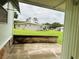 Back patio area with brick planter and view of neighboring home at 106 Azalea Trl, Leesburg, FL 34748