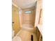 Bathroom features a shower-tub combo and hand rails at 106 Azalea Trl, Leesburg, FL 34748