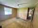 Bedroom with wood paneled walls, carpet and natural light from a window at 106 Azalea Trl, Leesburg, FL 34748