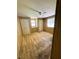 This bedroom features dual closets, a built-in vanity, wood paneled walls and carpet at 106 Azalea Trl, Leesburg, FL 34748