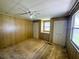 Bedroom features dual closets, a built-in vanity, wood paneled walls and carpet at 106 Azalea Trl, Leesburg, FL 34748