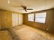 Bedroom with carpet, two windows and large closet at 106 Azalea Trl, Leesburg, FL 34748