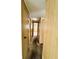 View of carpeted hallway with paneled walls and access to rooms at 106 Azalea Trl, Leesburg, FL 34748