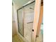 Shower with glass doors and tiled walls at 106 Azalea Trl, Leesburg, FL 34748
