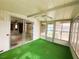 Enclosed sunroom with windows, a ceiling fan, and direct access to the living room at 106 Azalea Trl, Leesburg, FL 34748