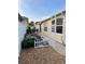 Delightful backyard garden with colorful flowers, a white picket fence, and an elegant pergola at 1130 Pelion Pl, The Villages, FL 32162