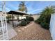 Lush backyard with a luxurious hot tub under a gazebo, surrounded by tropical plants and a stone pathway at 1130 Pelion Pl, The Villages, FL 32162