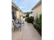 Serene backyard patio with comfortable seating and vibrant flower beds, perfect for outdoor relaxation at 1130 Pelion Pl, The Villages, FL 32162