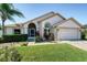 Charming single-story home featuring a well-manicured lawn and inviting front entrance at 115 Henue Ct, Davenport, FL 33896