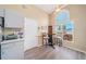 Bright kitchen with a cozy breakfast nook offering pleasant backyard views from the arched window at 115 Henue Ct, Davenport, FL 33896