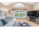 Bright living room featuring a view of the refreshing pool area and a comfortable seating arrangement at 115 Henue Ct, Davenport, FL 33896
