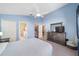 Serene main bedroom with closet, dresser, and ensuite bathroom at 115 Henue Ct, Davenport, FL 33896