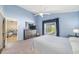 Comfortable main bedroom with blue walls, window, dresser, and doorway to adjacent rooms at 115 Henue Ct, Davenport, FL 33896