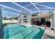 Enjoy this refreshing pool featuring a screened-in enclosure with a patio and solar panels on the home at 115 Henue Ct, Davenport, FL 33896