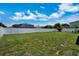 Spacious backyard with a lush lawn, privacy fence, and room to run and play at 130 Evergreen Dr, Auburndale, FL 33823