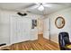Cozy bedroom featuring a ceiling fan, hardwood floors and closet for ample storage at 130 Evergreen Dr, Auburndale, FL 33823