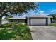 Charming single-story home with a well-maintained lawn, mature tree, and inviting curb appeal at 130 Evergreen Dr, Auburndale, FL 33823
