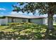 Beautiful home with mature tree providing shade on the lush green lawn, creating a serene ambiance at 130 Evergreen Dr, Auburndale, FL 33823