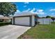 Attached two-car garage providing convenience and ample parking space, with an adjacent fenced area at 130 Evergreen Dr, Auburndale, FL 33823