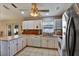 Well-lit kitchen with white cabinets, stainless steel appliances, and ample counter space at 130 Evergreen Dr, Auburndale, FL 33823