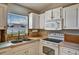 Charming kitchen showcasing white cabinets, modern appliances, and a double stainless steel sink at 130 Evergreen Dr, Auburndale, FL 33823