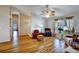 Bright living room featuring hardwood floors, ample natural light, and a ceiling fan, creating a comfortable space at 130 Evergreen Dr, Auburndale, FL 33823