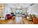 Bright living room featuring hardwood floors, large windows, and comfortable armchairs at 130 Evergreen Dr, Auburndale, FL 33823