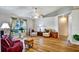 Inviting living room featuring hardwood floors, a vaulted ceiling, and large windows for natural light at 130 Evergreen Dr, Auburndale, FL 33823