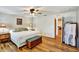 Comfortable bedroom featuring hardwood floors, a ceiling fan, and tasteful decor and plenty of light at 130 Evergreen Dr, Auburndale, FL 33823