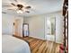 Well-lit main bedroom with hardwood floors, ceiling fan, and ensuite bathroom and walk-in closet at 130 Evergreen Dr, Auburndale, FL 33823