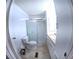 Bathroom with enclosed shower, toilet, vanity with sink, and tile flooring at 15 Ne 63Rd Ct, Ocala, FL 34470