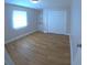A naturally lit bedroom featuring wood-look floors, closet, and an incorporated vanity area at 15 Ne 63Rd Ct, Ocala, FL 34470