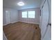 A bright and airy bedroom with wood-look floors and two windows letting in natural light at 15 Ne 63Rd Ct, Ocala, FL 34470