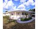 Inviting home with a covered entrance, manicured landscaping, and an attached carport for convenient parking at 15 Ne 63Rd Ct, Ocala, FL 34470