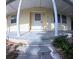 Close-up of front porch steps with decorative plants, leading to a charming, covered entrance at 15 Ne 63Rd Ct, Ocala, FL 34470