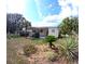 Attractive home showcasing a lush front yard with a variety of plants and trees, enhancing its curb appeal at 15 Ne 63Rd Ct, Ocala, FL 34470