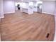 Open concept living space featuring wood floors, a kitchen island, and modern appliances, ideal for entertaining at 15 Ne 63Rd Ct, Ocala, FL 34470
