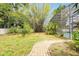 Expansive backyard with lush bamboo and walkway leading to a refreshing pool, perfect for outdoor enjoyment at 1502 Hempel Ave, Windermere, FL 34786