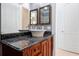 A bathroom offers a dark countertop and wood cabinet beneath a ceramic sink at 1502 Hempel Ave, Windermere, FL 34786