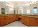 Spacious bathroom with double sinks, granite countertops, and elegant light fixtures at 1502 Hempel Ave, Windermere, FL 34786