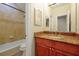 Bathroom featuring a tiled shower, vanity, and decorative mirror, offering a functional and stylish space at 1502 Hempel Ave, Windermere, FL 34786