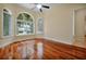 Bedroom is brightly lit with hardwood floors, base molding, and two large windows overlooking the outdoors at 1502 Hempel Ave, Windermere, FL 34786