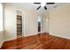 Bright bedroom features hardwood floors, a ceiling fan, closet, and easy access to the bathroom at 1502 Hempel Ave, Windermere, FL 34786