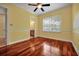 Bedroom featuring hardwood floors, a large window, and ensuite access to a well-appointed bathroom at 1502 Hempel Ave, Windermere, FL 34786