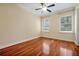 Bedroom features hardwood floors, a ceiling fan, base molding, and two windows at 1502 Hempel Ave, Windermere, FL 34786
