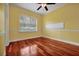 Bedroom features hardwood floors, a large window, and base molding at 1502 Hempel Ave, Windermere, FL 34786