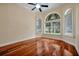 Bedroom with three large windows featuring lovely backyard views and beautiful hardwood floors at 1502 Hempel Ave, Windermere, FL 34786