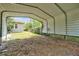 Features open carport with grassy yard, offering parking and outdoor space at 1502 Hempel Ave, Windermere, FL 34786